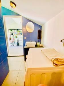 a bathroom with a bed and a sink and a mirror at Golden Wave Surf Roof Terrace in Corralejo