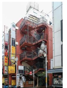a red brick building with a fire escape at bnb plus Ueno Park Female only in Tokyo