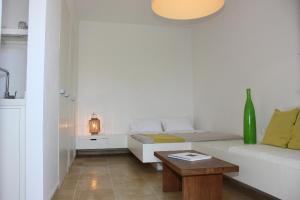 a living room with a white couch and a table at Orloff Resort in Spetses