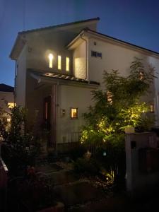 a house with lights on the side of it at night at B&B legare in Gifu