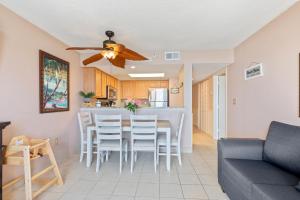 a living room and kitchen with a table and chairs at Atlantica Towers Condo w Balcony by Hosteeva in Myrtle Beach