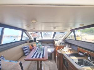 a boat with a table and a sink in it at *NEW* GORGEOUS BOAT STAY WITH VIEWS! in Brixham