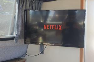 a television with the words netflix on the screen at *NEW* GORGEOUS BOAT STAY WITH VIEWS! in Brixham