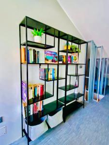 a book shelf with books and a plant on it at Golden Wave Surf Roof Terrace in Corralejo