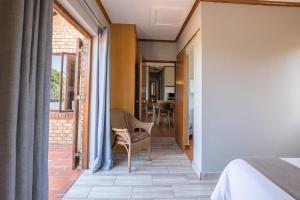 a bedroom with a bed and a balcony at Greenway Woods Accommodation in White River