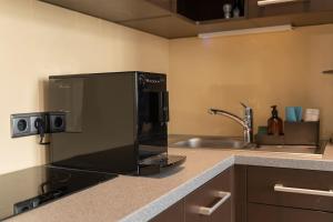 a kitchen with a microwave and a sink at Levestate Apartments Klährgasse Vol 2 in Vienna