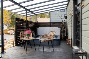 a patio with two chairs and a table on a deck at Levi Secret Igloo Ruska in Levi