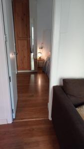 a hallway leading to a bedroom with a wooden floor at Nido MAD in Madrid