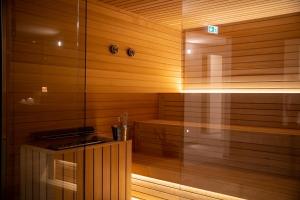 a sauna with wooden walls and a wooden floor at Hotel Galassia Suites & Spa in Lido di Jesolo