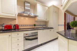 A kitchen or kitchenette at XPCE D CARLOS GARDENS Apartment