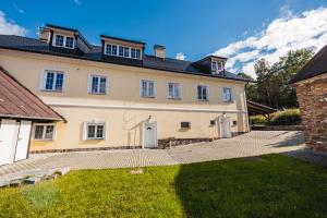 una casa grande con un patio delante en Apartmán Hartmanice, en Sušice