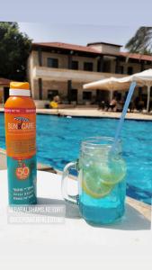 a drink in a mason jar next to a swimming pool at Bab Al Shams Resort in Jericho