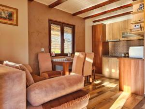 a kitchen and living room with a couch and a table at Zoranovi konaci in Jevtići