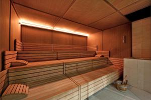 an empty lecture hall with wooden benches and a light at Basiliani - CDSHotels in Otranto