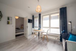 a living room with a table and a bedroom at Moderne EG-Wohnung in Sudenburg mit Parkplatz, TOP Anbindung in Magdeburg