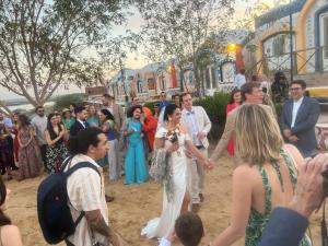 a bride and groom holding hands while walking down the street at Artika Wadi Kiki Hotel in Aswan