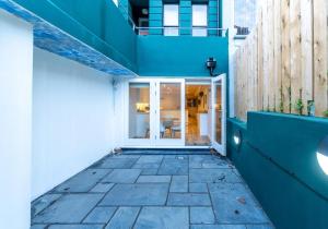 a building with blue walls and a walkway at The Narrow Studio By My Getaways in Brighton & Hove
