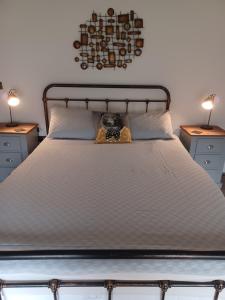a bedroom with a bed with two tables and two lamps at 2 Bear Barns in Rhayader