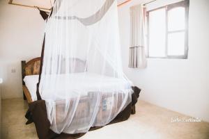 A bed or beds in a room at Uroa Zanzibar Vera Beach Hotel by Moonshine