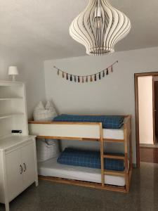 a room with a bunk bed and a chandelier at Ferienwohnung Villa Hygge in Mitterteich