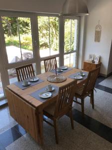 a wooden table with four chairs around it with at Ferienwohnung Villa Hygge in Mitterteich