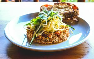 a plate of spaghetti and bread on a table at Munduk Menir Villas in Munduk +30 photos