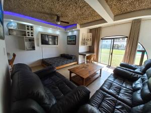 a living room with a couch and a table at Cabanas del Mar in Amanzimtoti