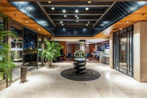 a lobby with plants in a building at Tzl Suites Hotel Nişantaşı in Istanbul