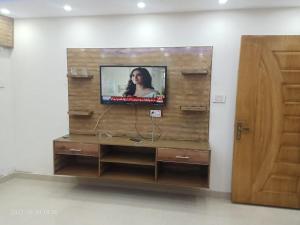 a tv on a wooden wall in a room at One bed lovely apartment in Rawalpindi