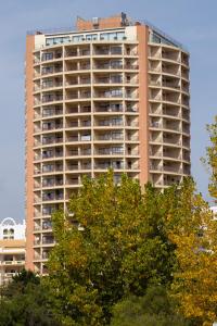 a tall apartment building with trees in front of it at ApartPatos Luxury Home in Portimão