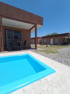 a swimming pool in front of a house at Casas de Cafayate in Cafayate