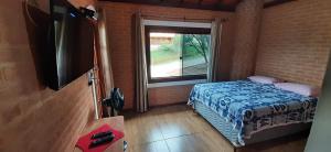 מיטה או מיטות בחדר ב-Casa Recanto da Serra