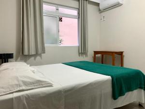 En eller flere senge i et værelse på LOFT Av Brasil bem localizado e Economico com Wi-Fi