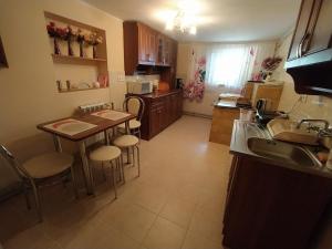 a kitchen with a table and some chairs in it at Apartament KARINA 2 in Tylicz