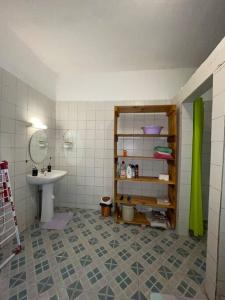 a bathroom with a sink and a mirror at Appartement à 2 pas de l'ilôt de Sada. in Sada