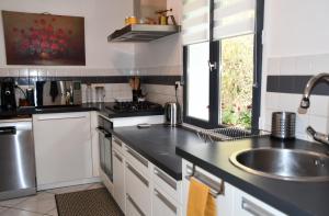 a kitchen with a sink and a counter top at Maison Marguerite in Bordères-Louron +36 photos