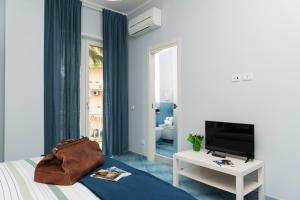 a bedroom with a bed with a television and a table at CAPRI B&B in Salerno