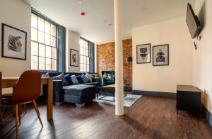 a living room with a couch and a table at The Cavern Quarter Aparthotel by UStay in Liverpool