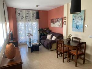 a living room with a couch and a table at Aguilas Paraiso in Águilas