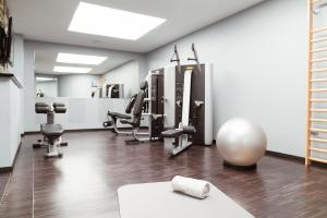 a room with a gym with exercise equipment in it at Carlton Hotel St Moritz - The Leading Hotels of the World in St. Moritz