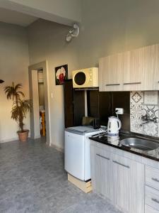 a kitchen with a sink and a counter top at Dto III Temperley in Temperley