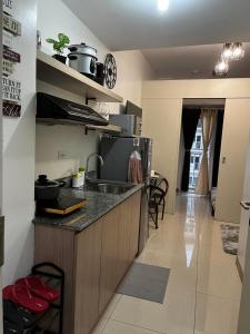 a kitchen with a sink and a counter top at Lovely 1BR Condo @ SM Southmall w/ Netflix & High Speed WIFI in Manila