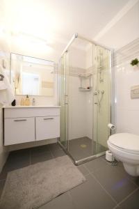 a bathroom with a glass shower and a toilet at Gorgeous - Red rock and Sea view. in Eilat