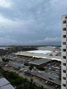 an aerial view of a parking lot with a building at Lovely 1BR Condo @ SM Southmall w/ Netflix & High Speed WIFI in Manila
