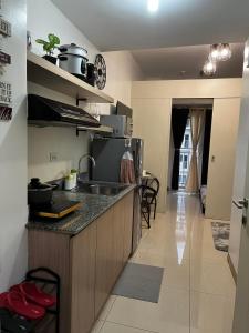 a kitchen with a sink and a counter top at Lovely 1BR Condo @ SM Southmall w/ Netflix & High Speed WIFI in Manila