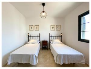 Postel nebo postele na pokoji v ubytování Villa Sevilla