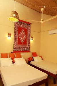 Voodi või voodid majutusasutuse The Tottam Beach Hotel - Trincomalee toas