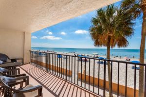 a balcony with chairs and a view of the beach at 104 Las Brisas Condo in St. Pete Beach