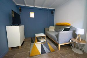 a living room with a couch and a tv at Marechal's Studio near train station & downtown in Nantes