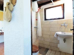 a bathroom with a toilet and a sink at Secluded holiday home in Borgo Valbelluna with garden 